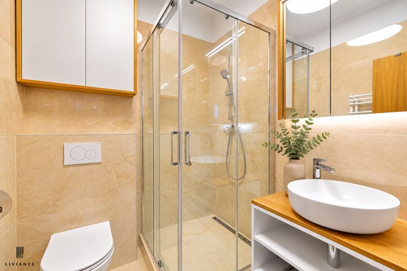 A bathroom with a shower and a sink in a 4-room apartment with wood decor.