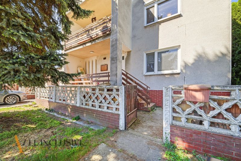 A family house in Topoľníky with a terrace, garden fence, and access walkway.