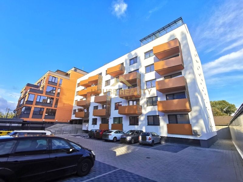 Apartment building on Trnavská Street in Bratislava - Ružinov with parking spaces in front of it.