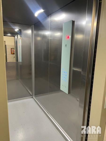 The interior of an elevator with modern lighting in a 3-room apartment.