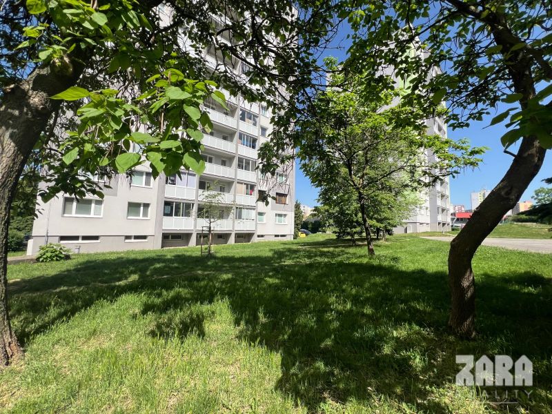 An apartment building surrounded by greenery and trees on Juhoslovanská Street, Sídlisko Ťahanovce.