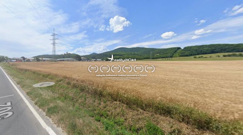 Agricultural and forest land on Továrenská Street in Smolenice with a view of the hills.
