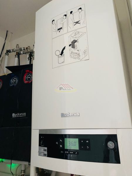 Buderus boiler with a digital display in the utility room of a family house.