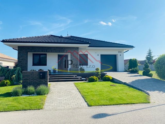 A family house on Jasná Street in Veľké Dvorníky, with a well-maintained garden and a garage.