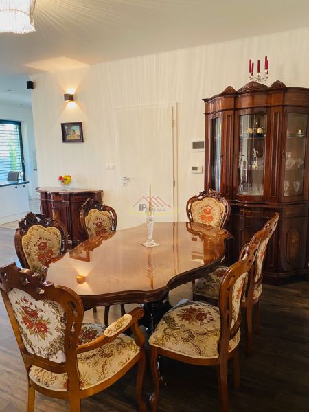 Dining room in a family house with historical furniture and a wooden decor floor.