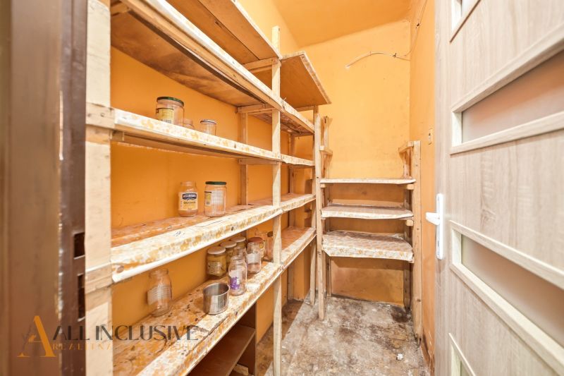 A pantry with shelves for preserves in a family house.