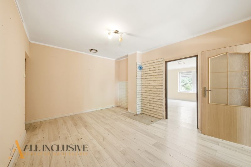 Interior of a family house with a wooden decor floor and light walls.