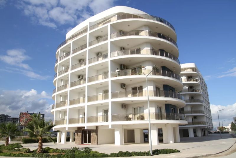 A building in Iskele with balconies, serving as apartments including 2-bedroom flats.