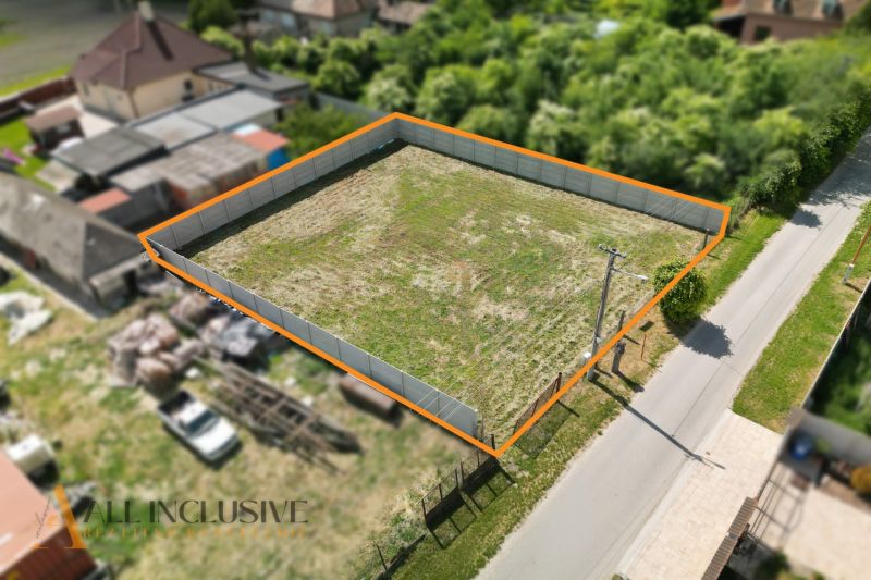 A residential plot on Ižop Street in Veľký Meder, fenced and ready for construction.