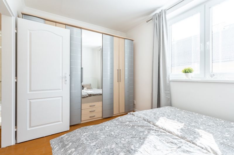A bright bedroom in a 3-room apartment with a built-in wardrobe and a large window.
