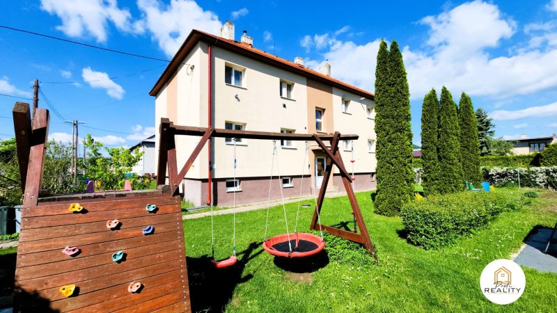 Two-story apartment building with a swing and greenery on Matice Slovenskej Street, Veľký Šariš.