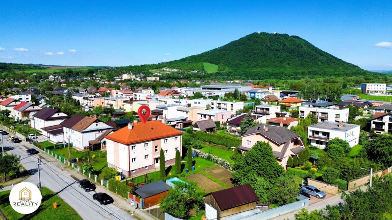 Veľký Šariš, Matice Slovenskej Street with a view of the hills and a residential area.