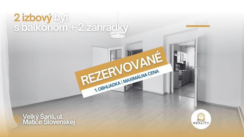 A 2-room apartment with a wooden decor floor and open doors to the kitchen.
