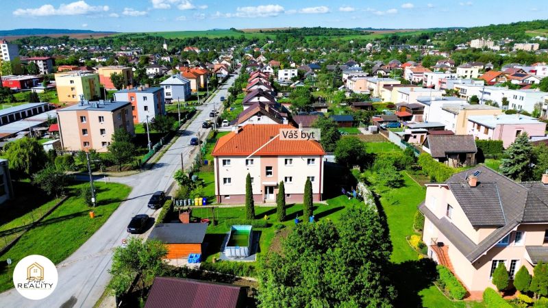 Aerial view of Matica slovenská in Veľký Šariš with a 2-room apartment in the foreground.
