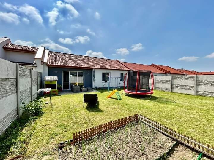 A family house in Rajka with a lawn, a children's playground, and space for gardening.