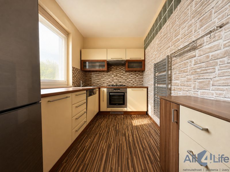 A kitchen in a 3-room apartment with a wooden decor floor and stylish surfaces.