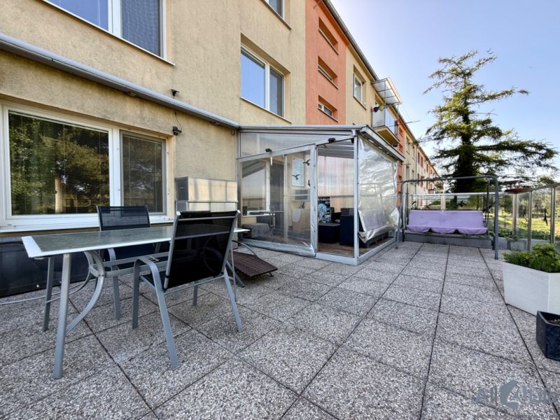 Exterior of a 3-room apartment on 9th May Housing Estate in the town of Vrbové with a terrace and seating area.