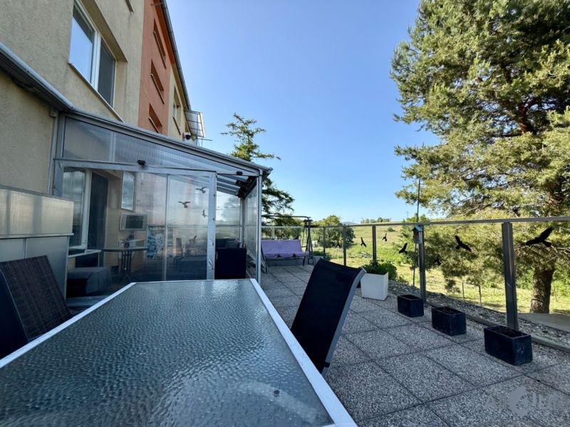 Terrace of a 3-room apartment on Sídlisko 9.mája in the town of Vrbové with a view of greenery.