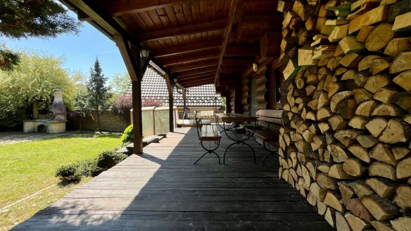 A family house with a wooden terrace and a supply of wood in Devínske Jazero, Bratislava.