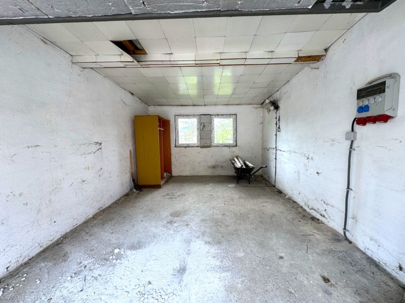 Spacious room with white walls, a wardrobe, and a window, Real estate - housing.