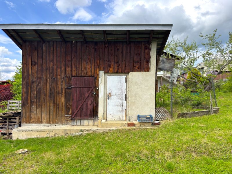 A wooden farm building on a plot in Lipany designated for living.