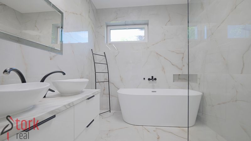 Bathroom with a freestanding bathtub and double sink in a family house.