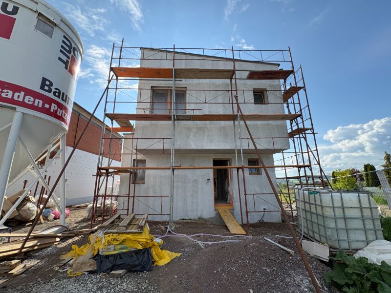 An unfinished family house in Prešov with scaffolding and building materials.