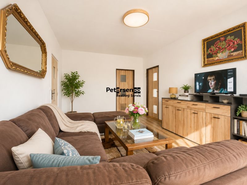 Living room in a 3-room apartment, with a comfortable sofa and a decorative mirror on the wall.