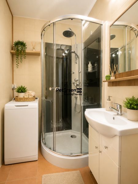 A bathroom with a corner shower, washing machine, and accessories in a 3-room apartment.