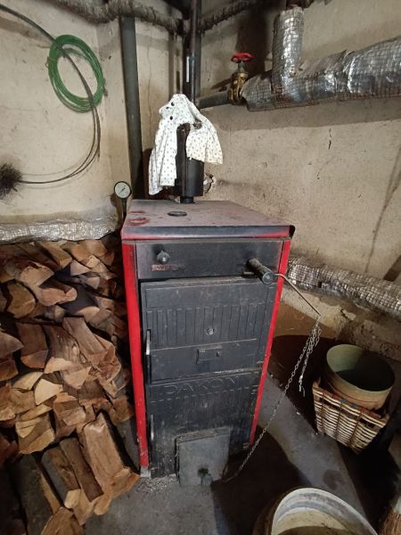 Wood-fired boiler and wood supply in a family house.