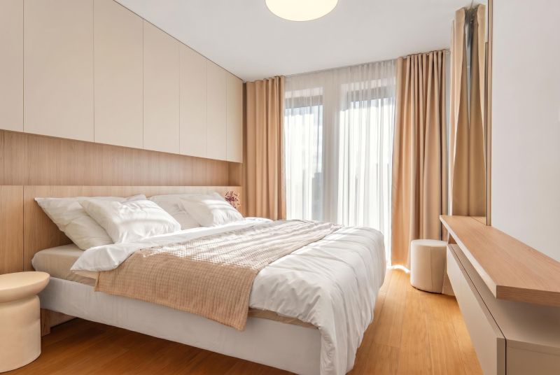 A bedroom with a bed and a wooden decor floor in a 3-room apartment.