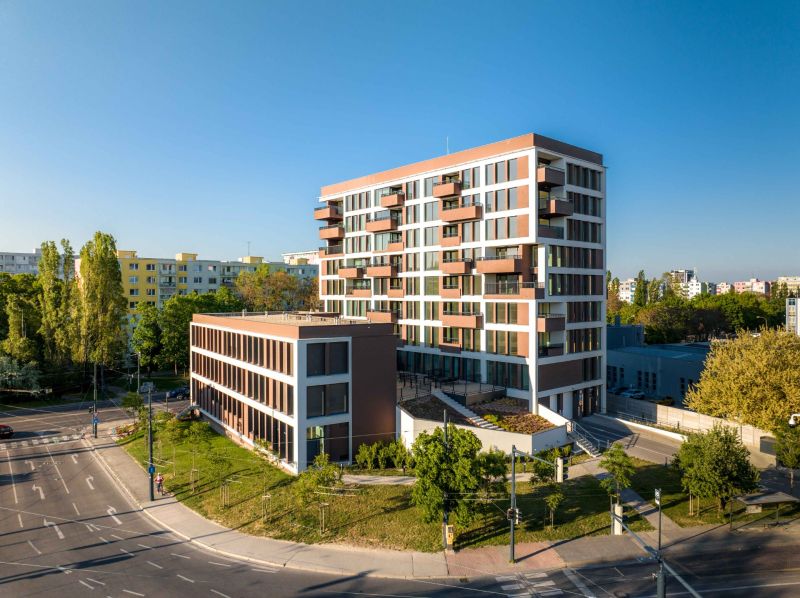 The building on Mierová Street in Bratislava - Ružinov, surrounded by greenery and situated by the road.