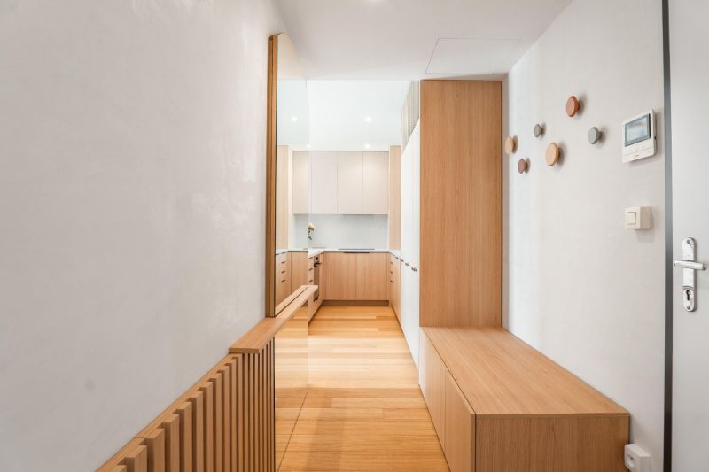 Interior of a 3-room apartment with a wooden decor floor and built-in wardrobes.