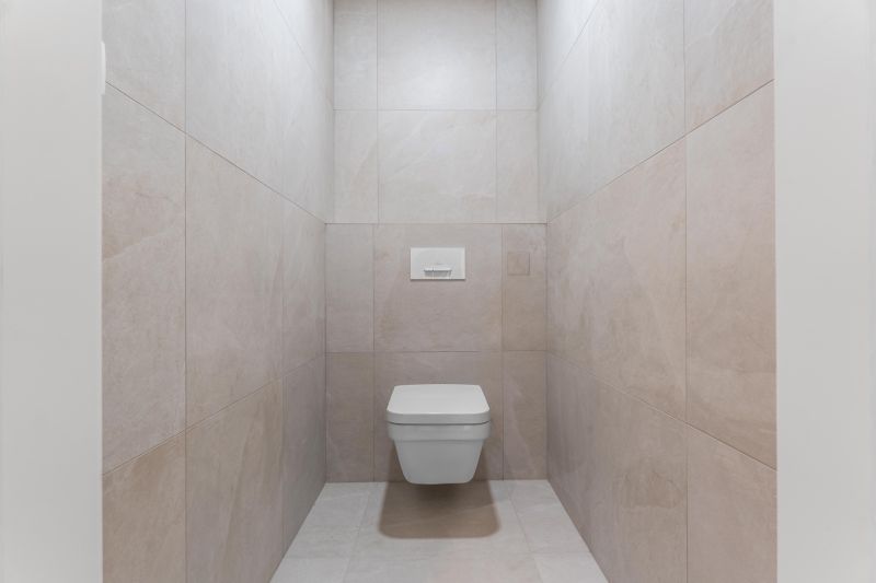 Stylish toilet with large-format tiles in a 3-room apartment.