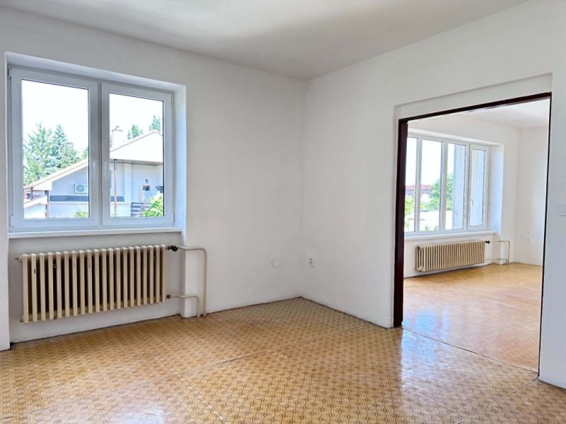 Interior of a family house with white walls and a wooden decor floor.