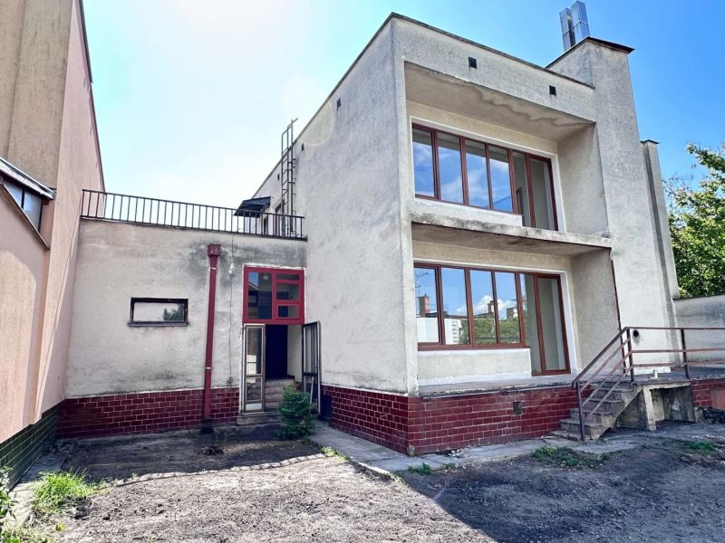 A family house in Dunajská Streda with a modernist design, red elements, and glass doors.