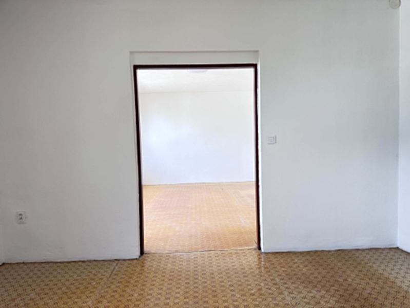 Two empty rooms in a family house with wooden decor floors.