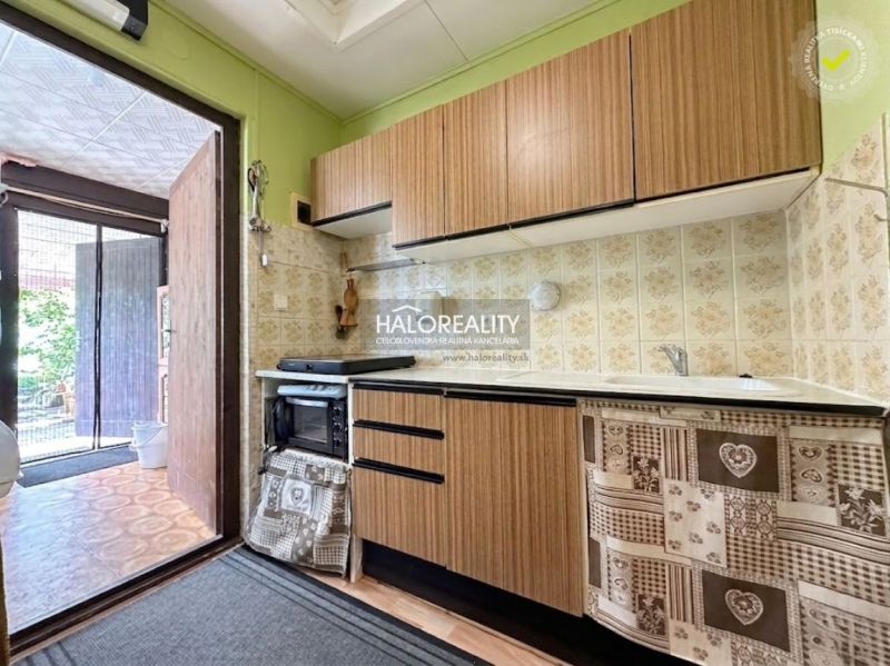 A kitchen in a cabin with wooden decor and a vintage kitchen unit.