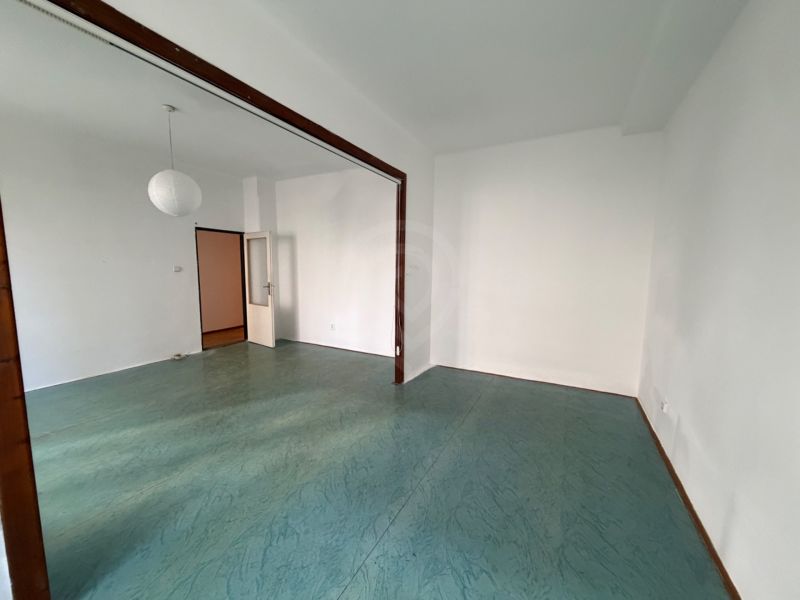 A bright room with a colorful floor and white walls in a 3-room apartment.