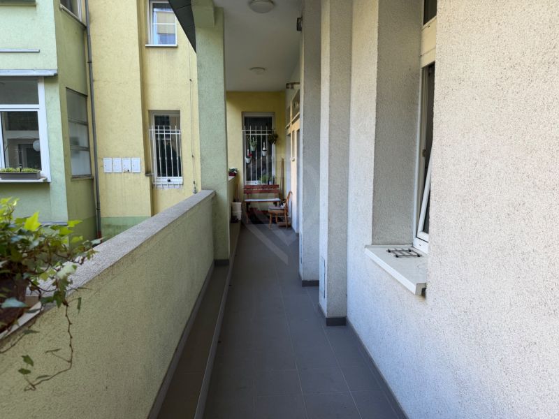 A balcony of a 3-room apartment with outdoor furniture and a view of the courtyard in Bratislava on Janáčkova.
