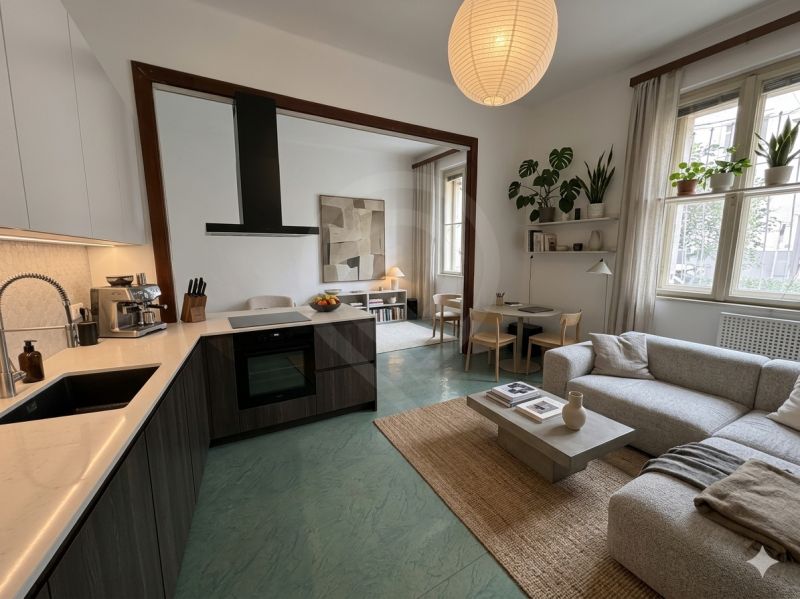 Spacious kitchen and living room in a 3-room apartment with a wooden decor floor.