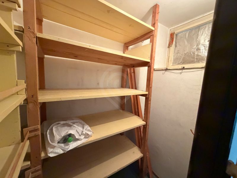 Storage room with shelves in a 3-room apartment, easy storage of items.