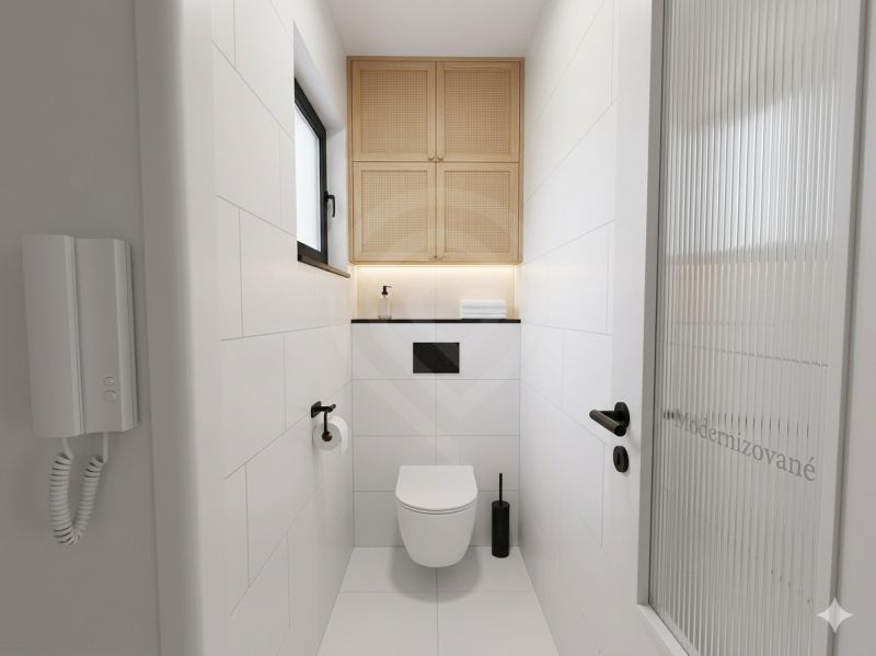 Bathroom in a 3-room apartment with white tiles and a wall-mounted toilet with storage space.