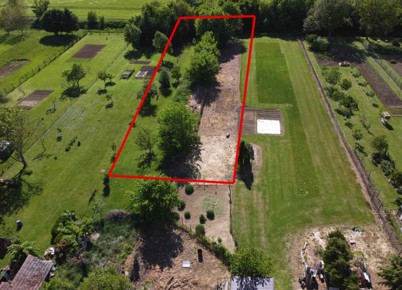 Aerial view of the marked plot with gardens in Hruboňovo, landscaped plots and vegetation.