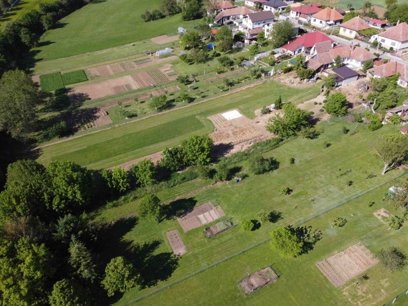 Aerial view of green and cultivated gardens in Hruboňovo near family houses.
