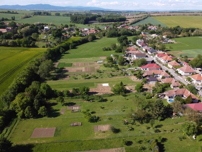 Aerial view of the gardens in Hruboňovo with village buildings and surrounding nature.