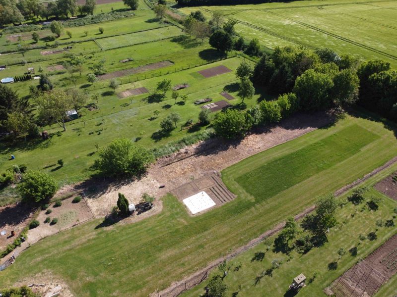 Aerial view of green gardens in Hruboňovo with trees and lawns.