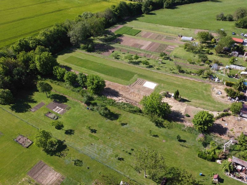 An aerial view of green gardens around Hruboňovo with various plots and trees.