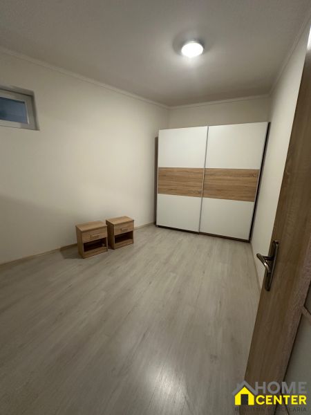 A room in a 3-room apartment with a wooden-decor floor and a wardrobe.