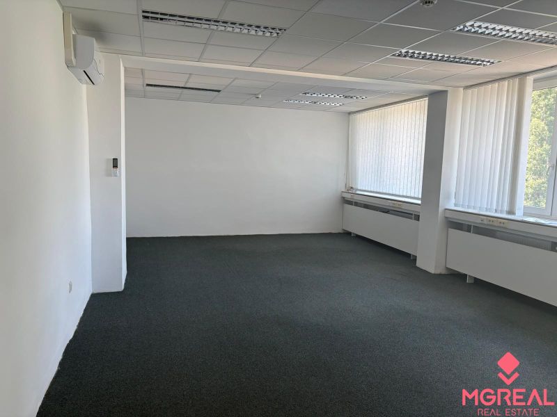 Offices with air conditioning, white walls, and large windows.
